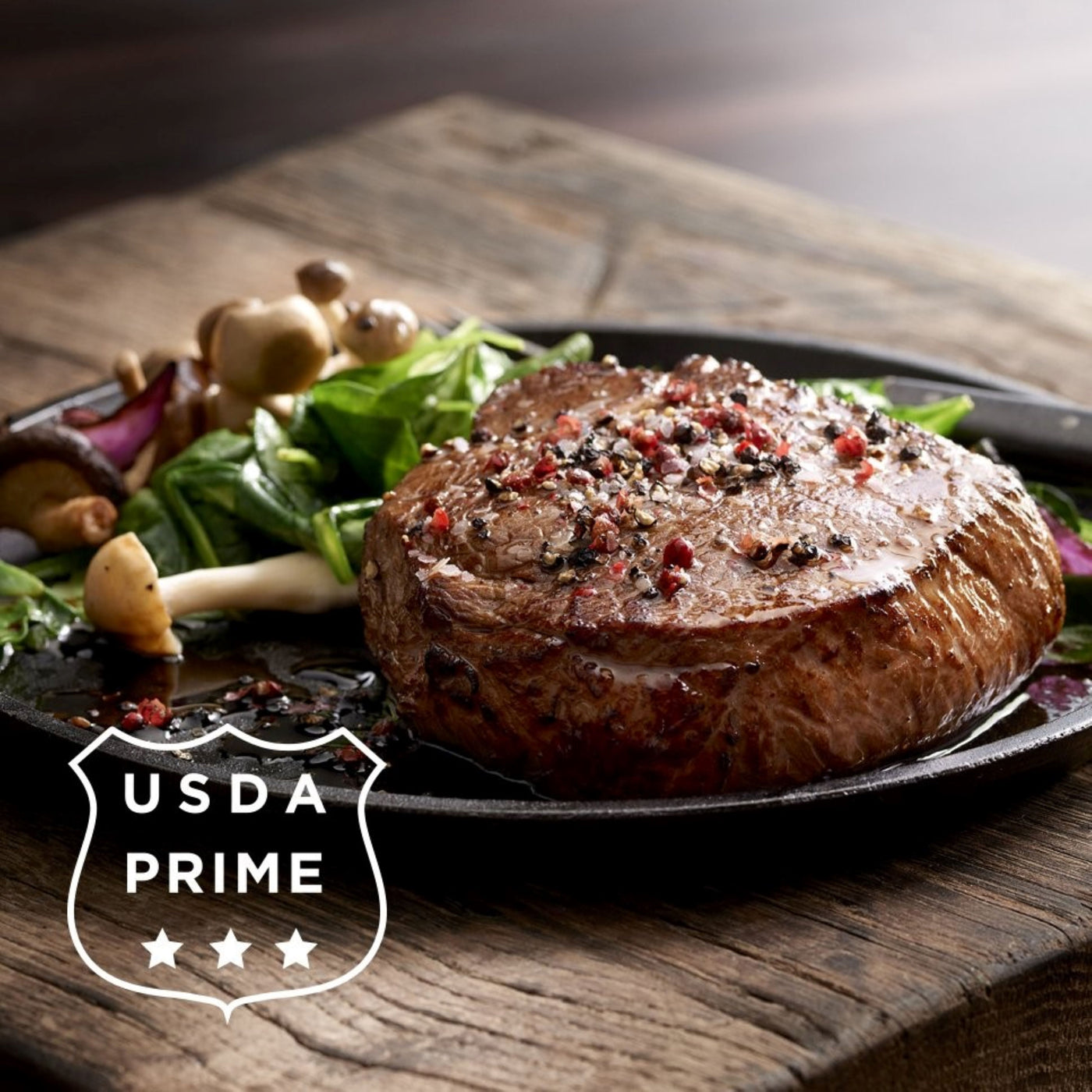 cooked usda prime top sirloin steak on plate with salad and seasoning